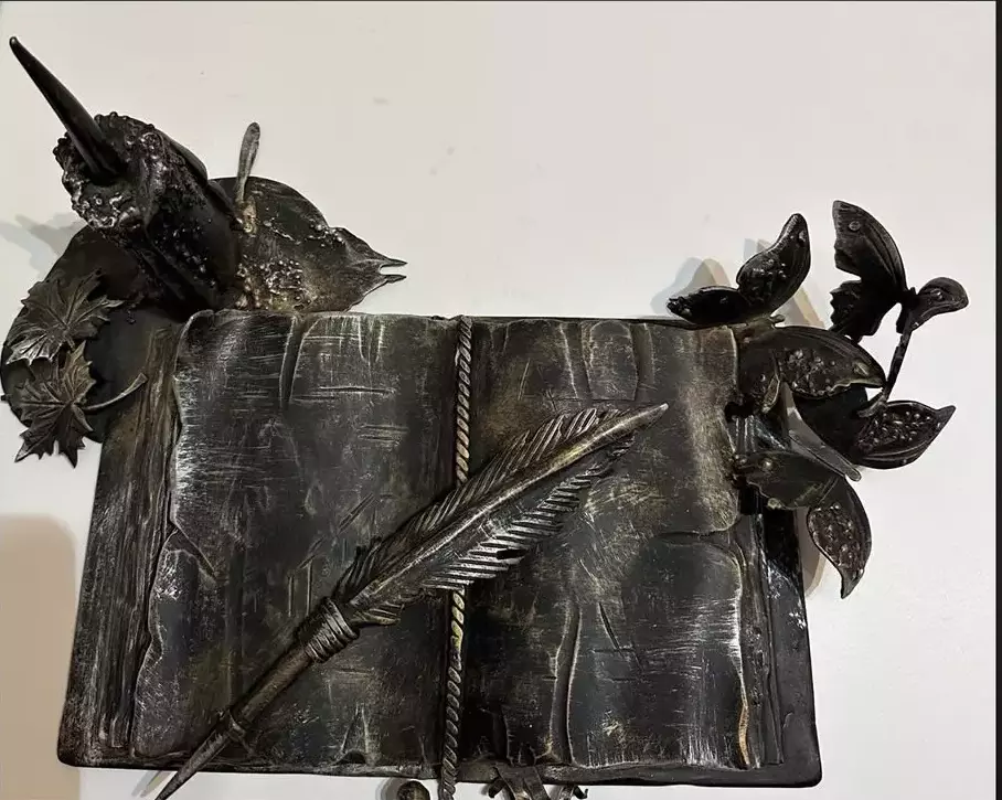 Metal artwork. Book of knowledge