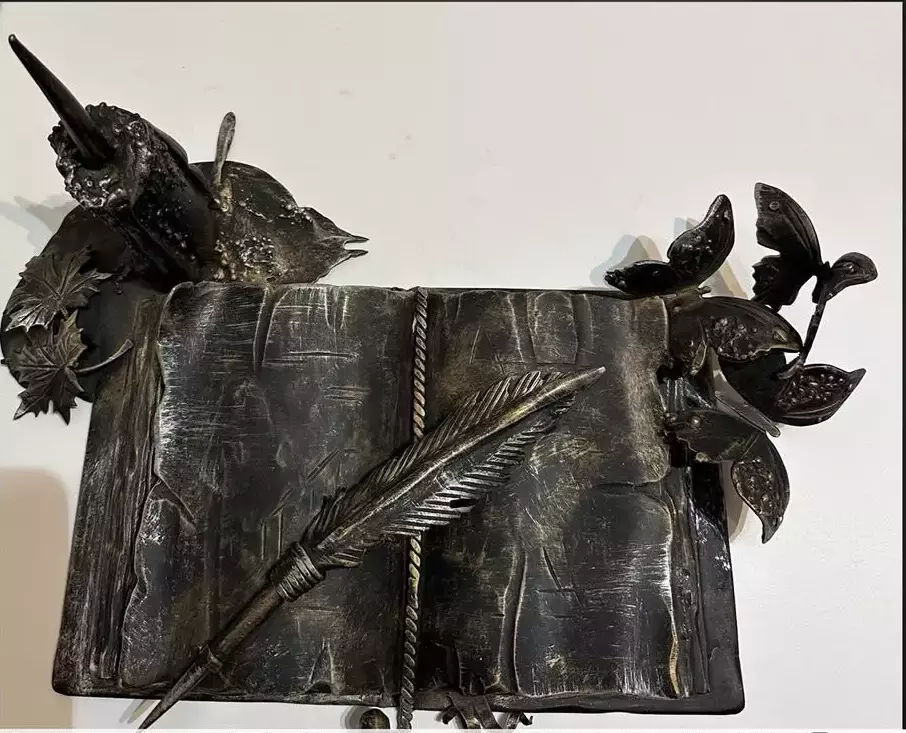 Metal artwork. Book of knowledge