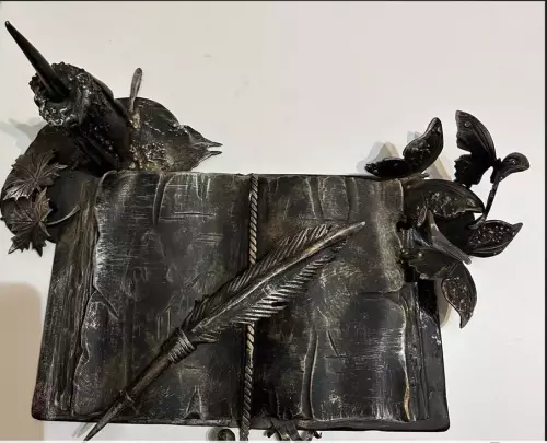Metal artwork. Book of knowledge